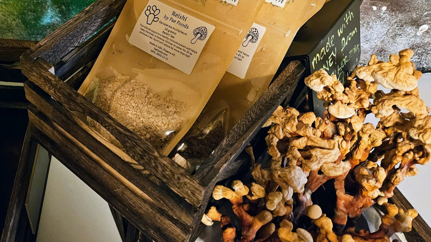 Reishi Mushroom dried and packed in pouches next to the whole dried mushroom on display in wooden crates 