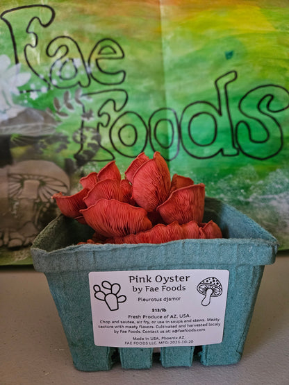 Pink oyster mushrooms in a labled produce container ready for sale